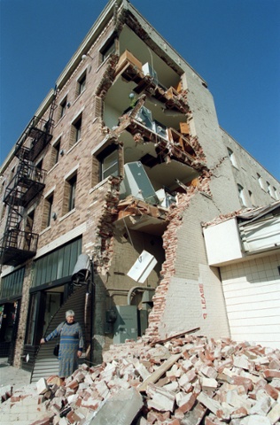 A woman walks over rubble after taking some of her belongings from her Hollywood Boulevard apartement building that was destroyed in the Northridge earthquake, January 19, 1994, in Hollywood, California. The Northridge earthquake occurred on January 17, 1994 at 4:31 AM Pacific Standard Time in Reseda, a neighborhood in the city of Los Angeles, California. The earthquake had a "strong" moment magnitude of 6.7, but the ground acceleration was the highest ever instrumentally recorded in an urban area in North America. (Photo credit should read TIMOTHY A. CLARY/AFP/Getty Images)